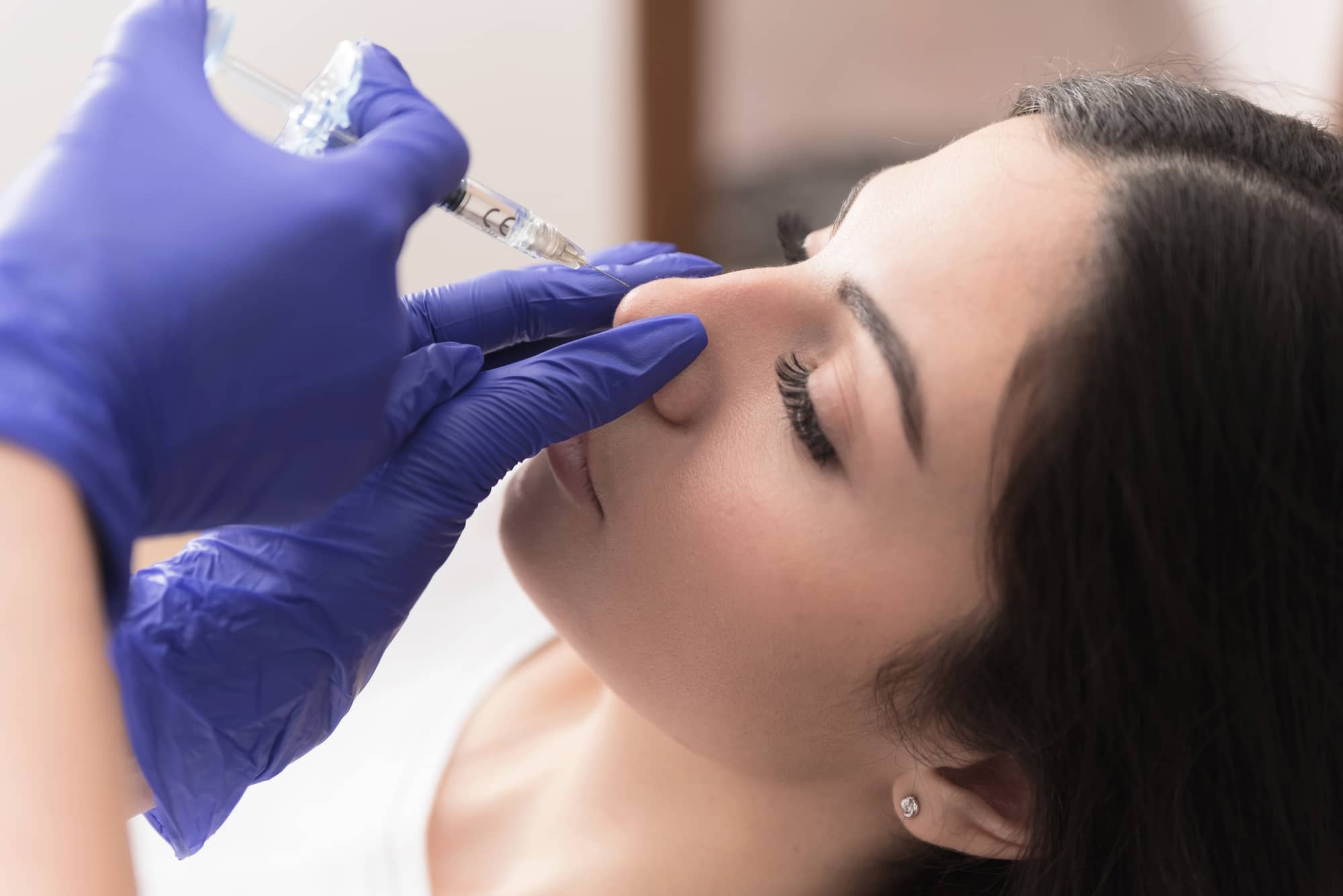doctor treating woman's eye with an injection