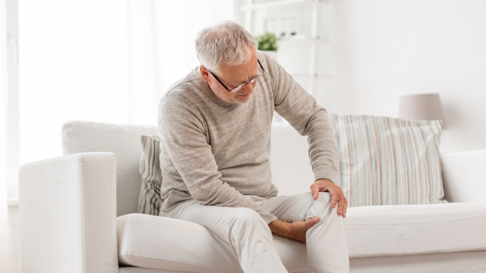Older man burdened by pain in the knee joint.