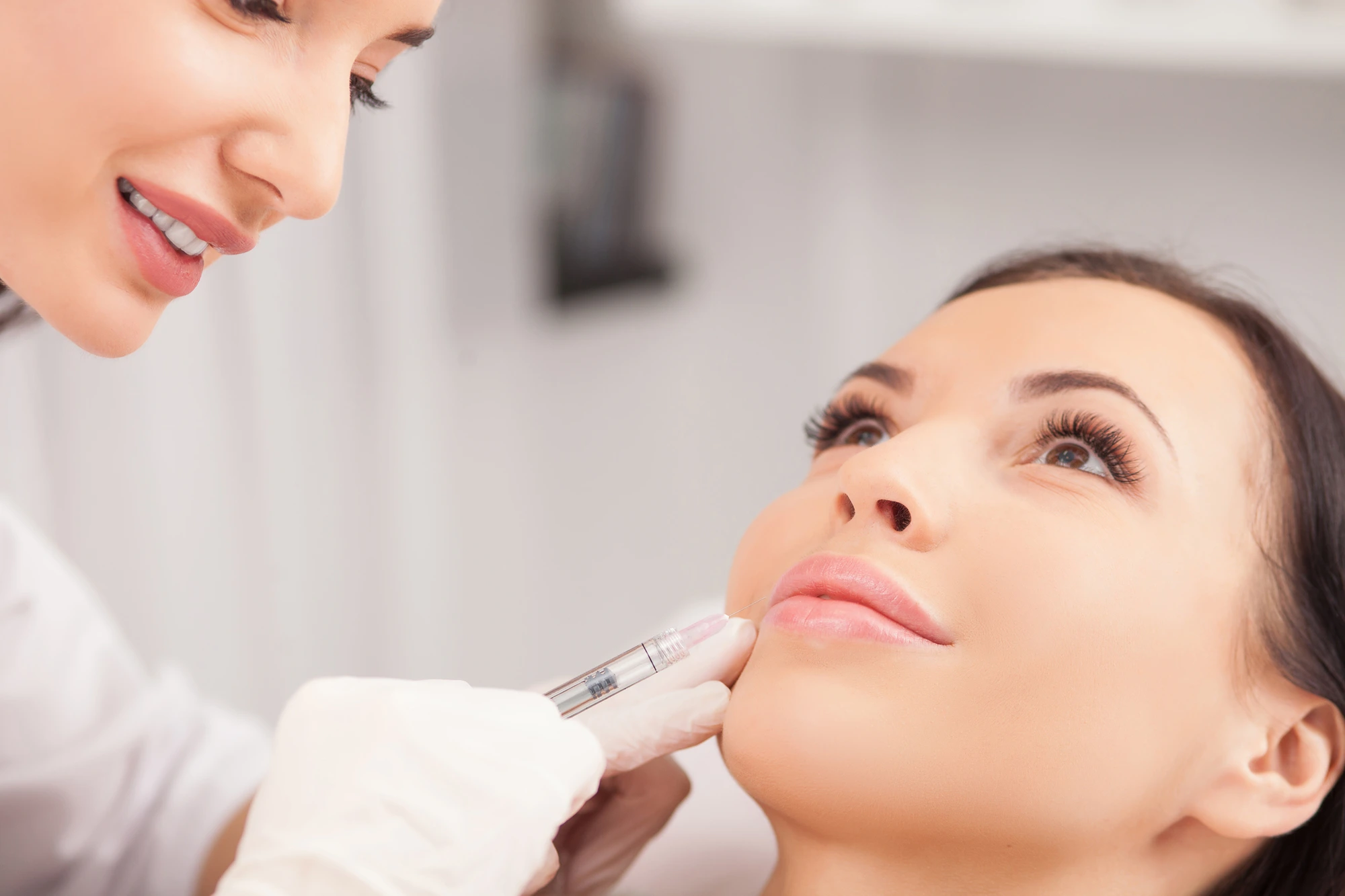 injector administering botox in mouth area