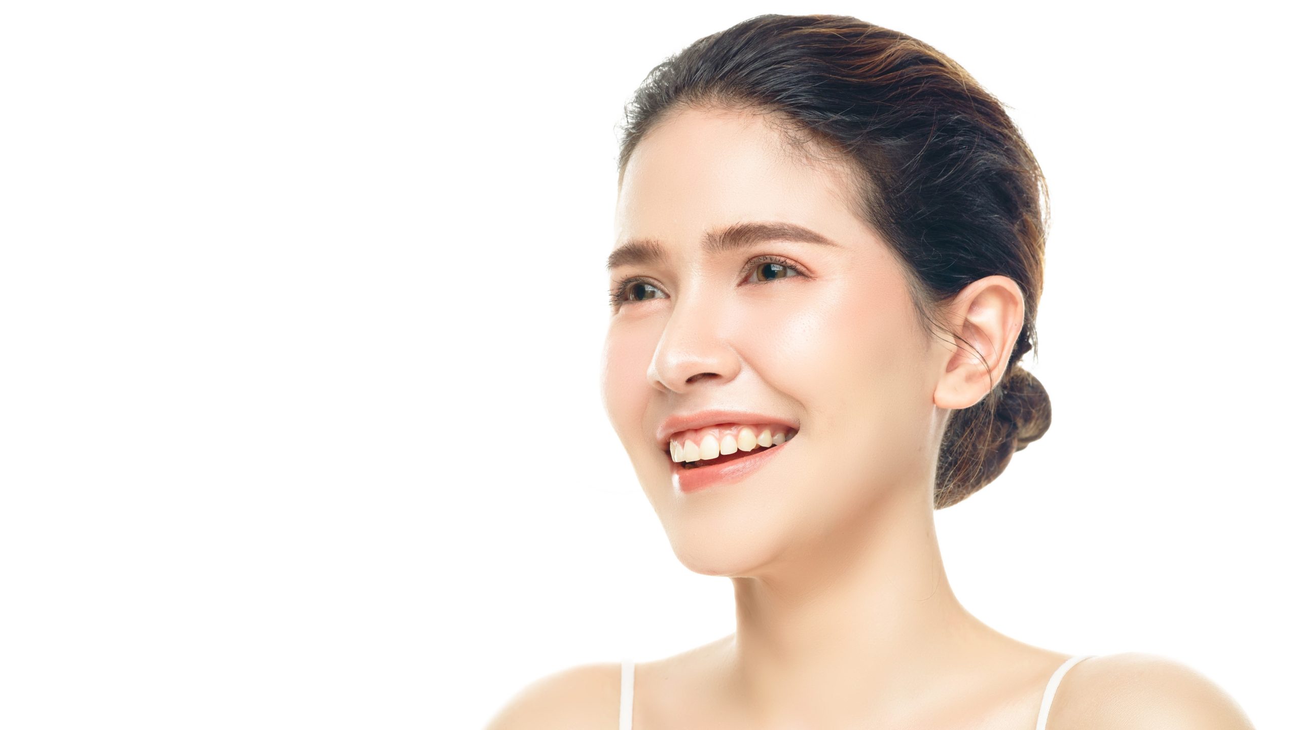 Happy woman with glowing skin thanks to Radiesse.