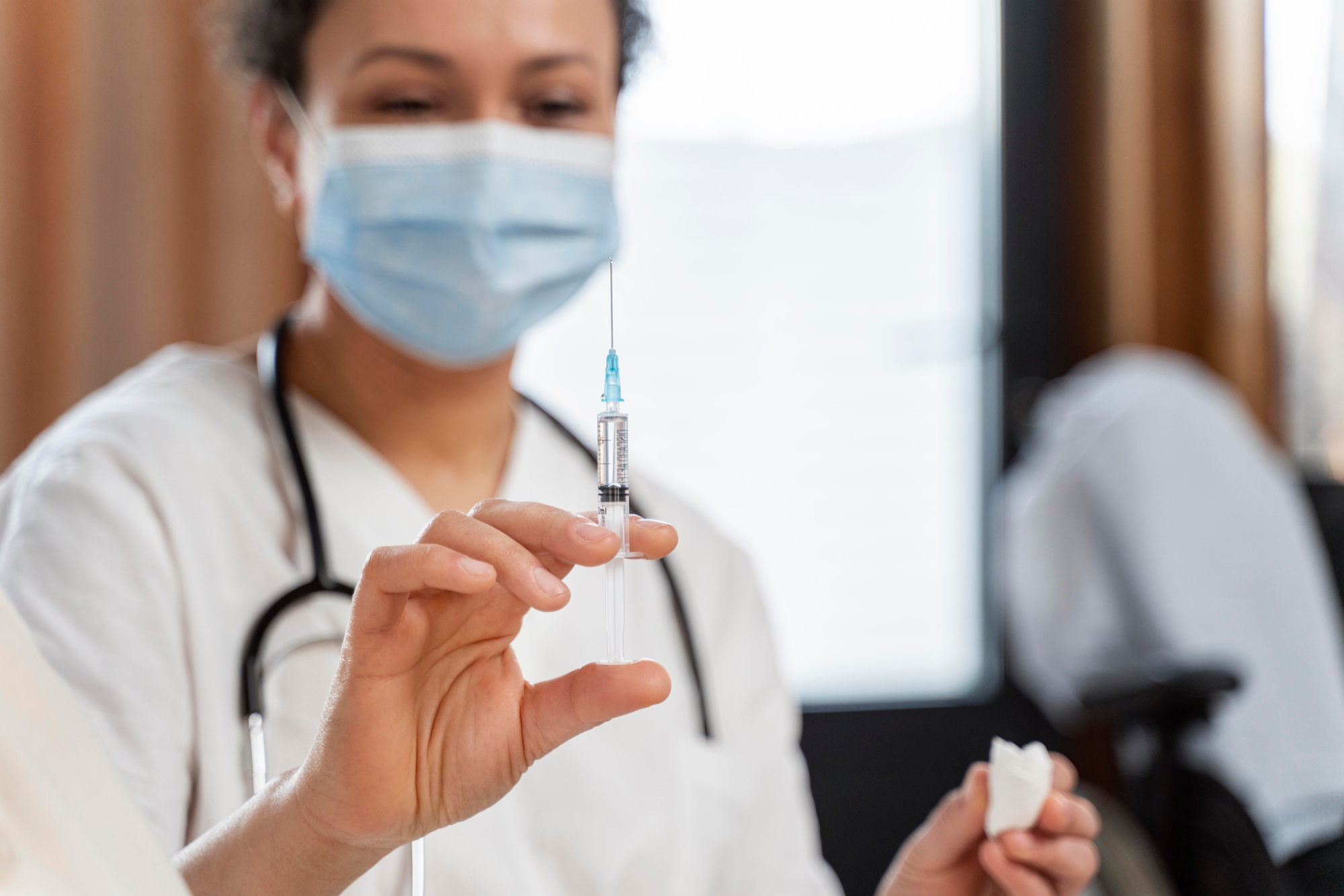 Aesthetic specialist preparing the syringe for Restylane treatment.