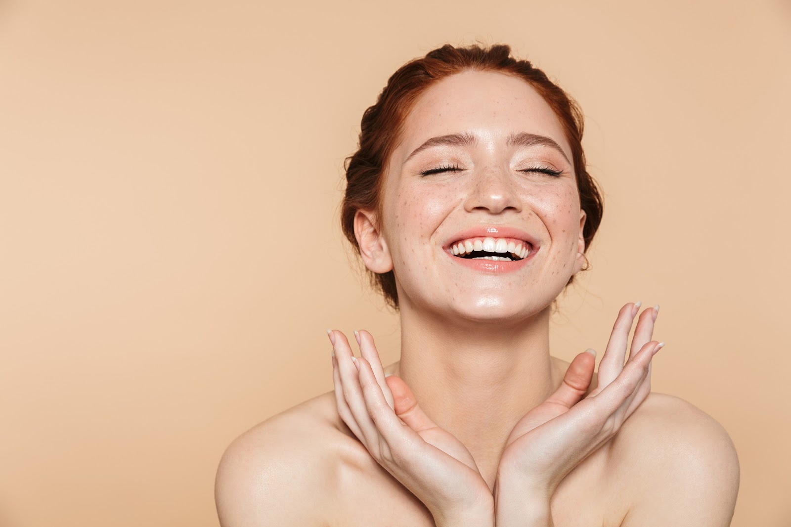 Woman celebrating her glowing and healthy skin.