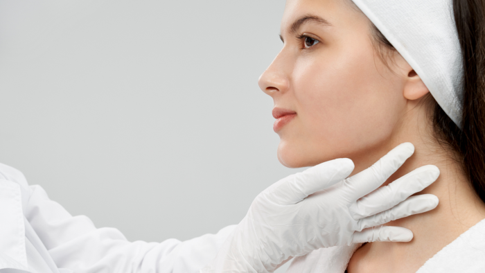 Healthcare professional checking a patient's facial structure.