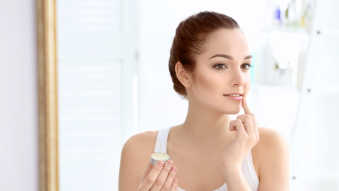 Woman performing her skincare routine.