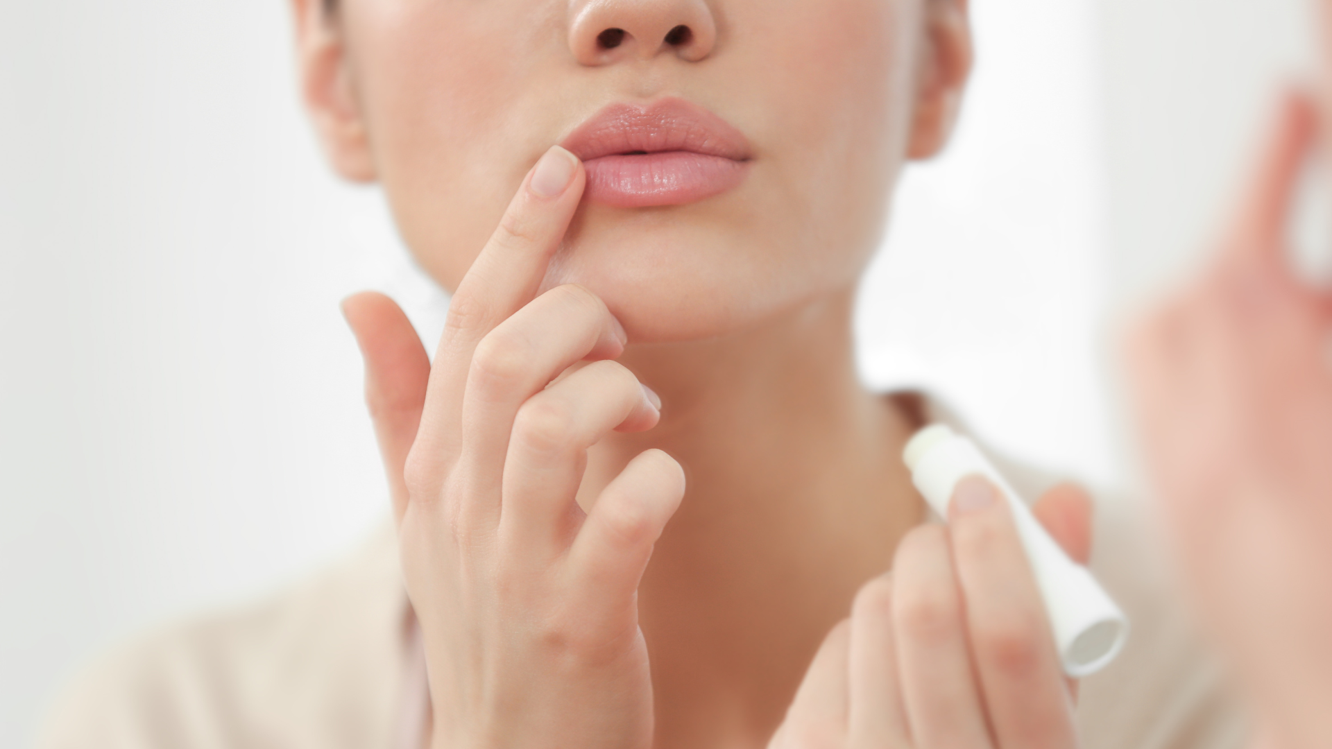 Woman with finger to her lips.