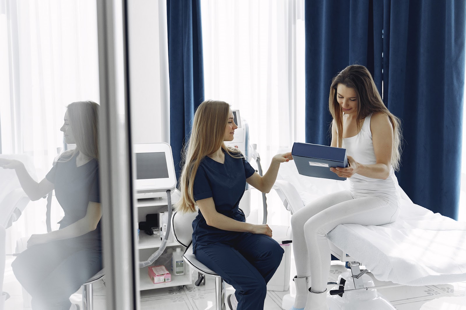 A healthcare professional discusses Restylane treatment with a female patient.