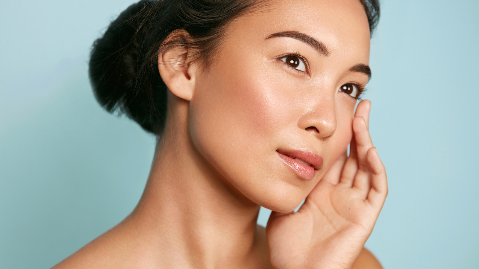 A woman with glowing skin and smooth under eyes after Restylane treatment.