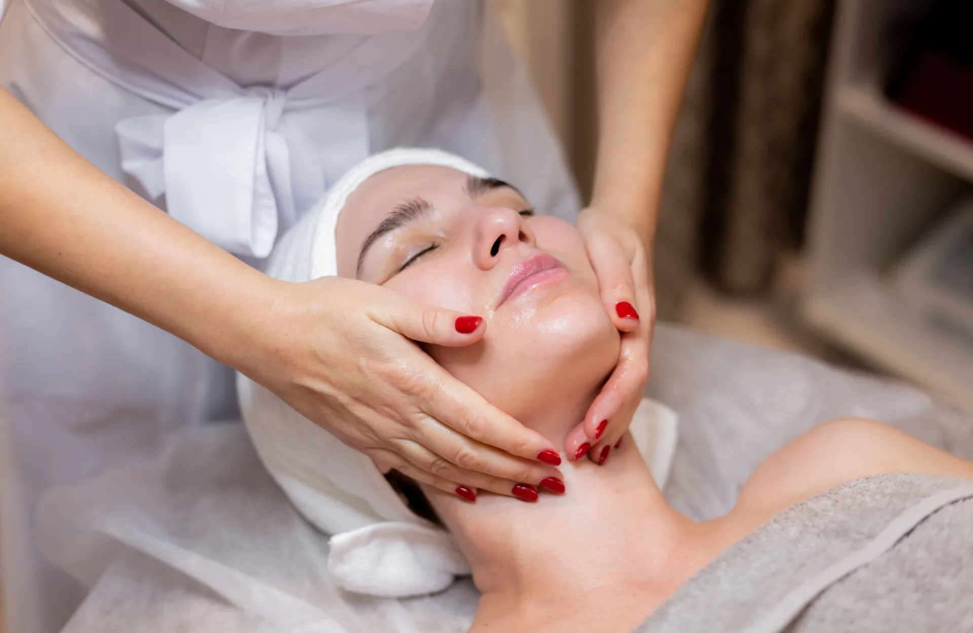Woman enjoying facial treatment