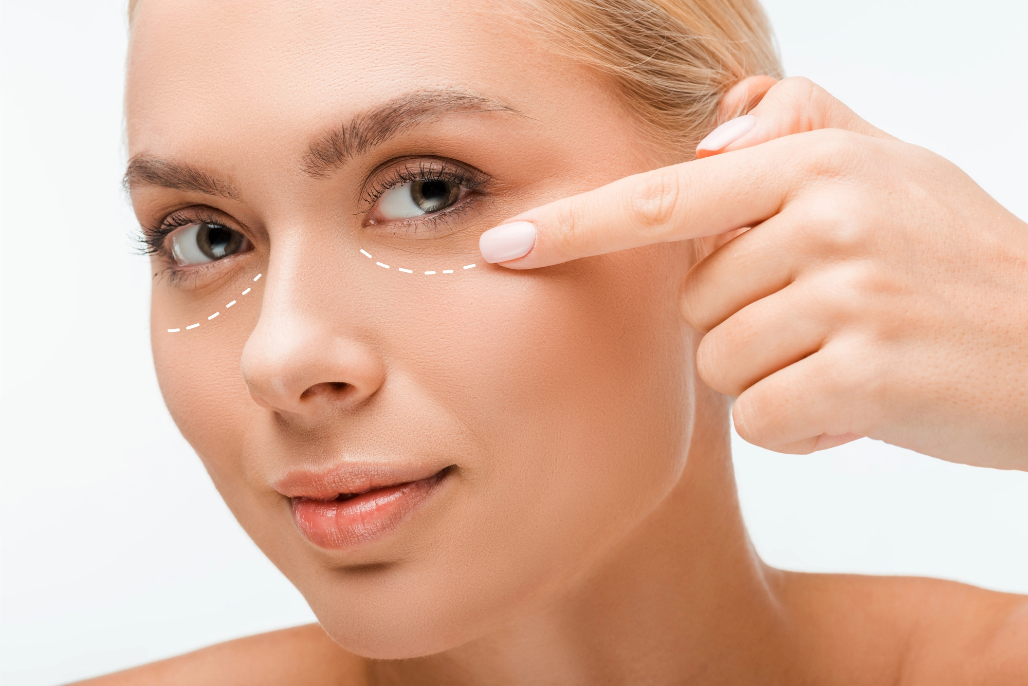 Woman pointing at her under eye area