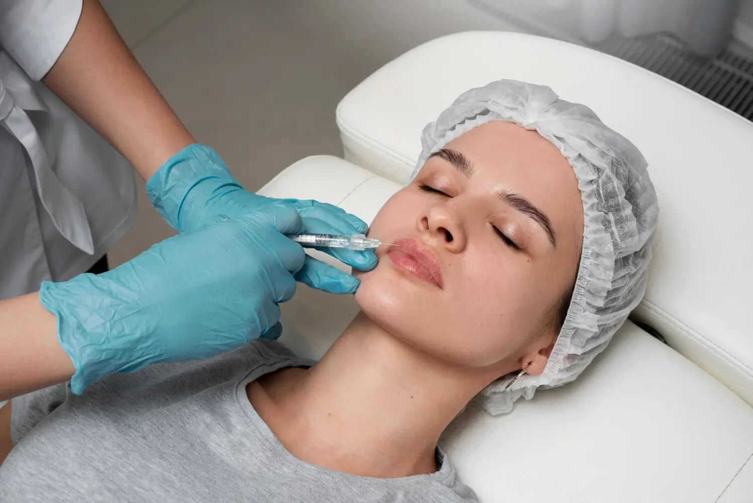 patient is lying in bed for a lip injection