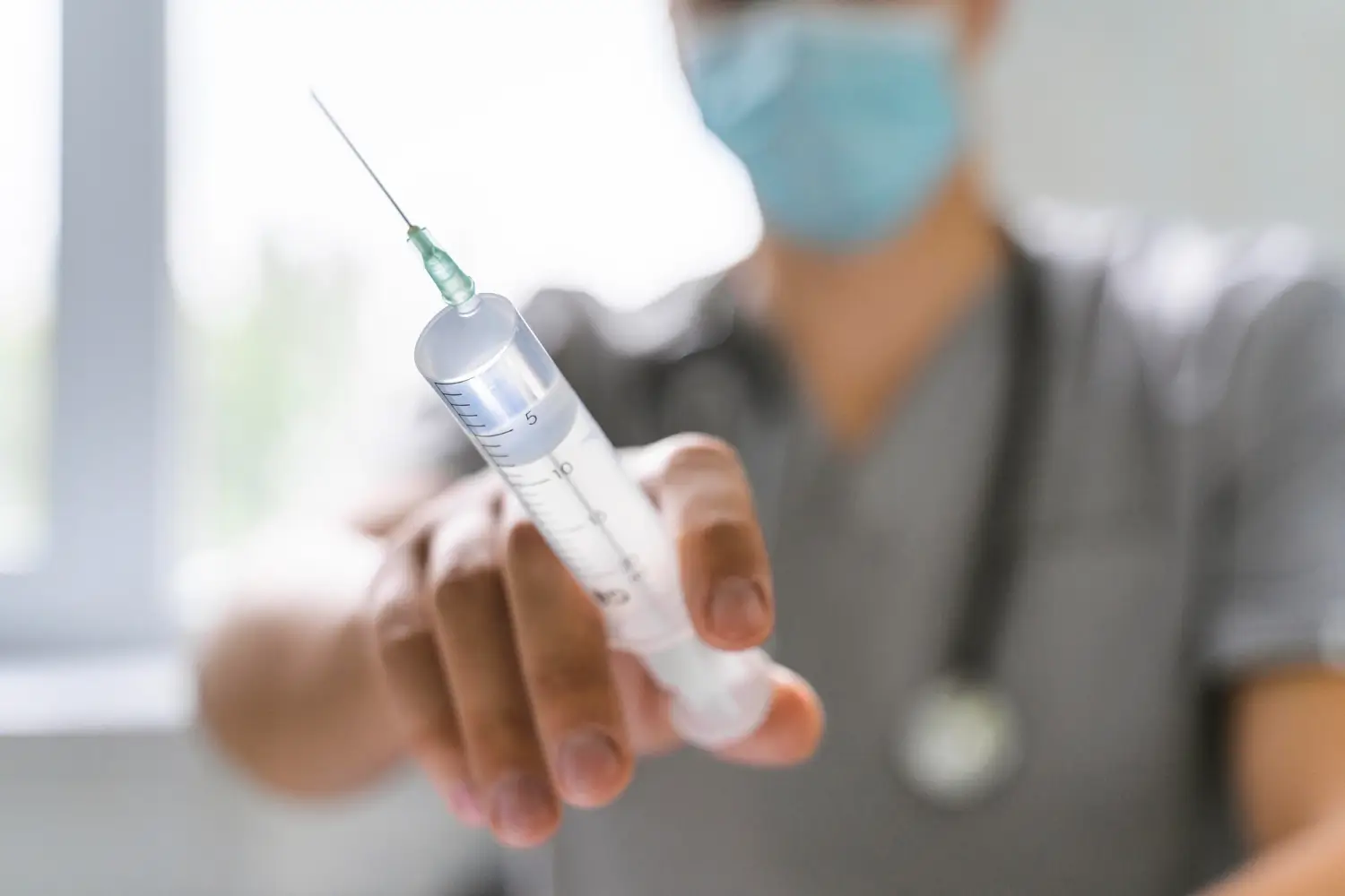doctor showing syringe for injection