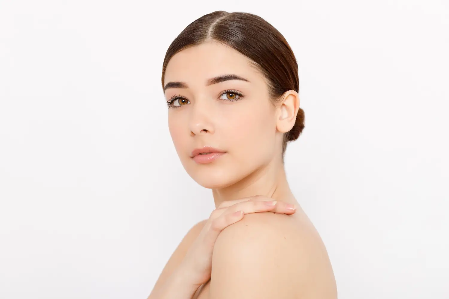 Natural beauty portrait of a woman with a calm expression and clear skin.