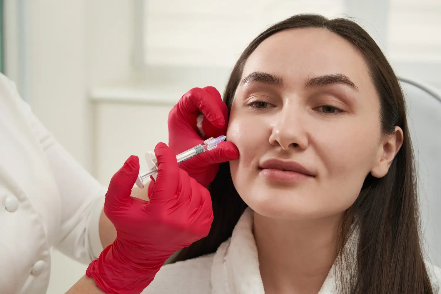 Patient receiving injections for facial rejuvenation.