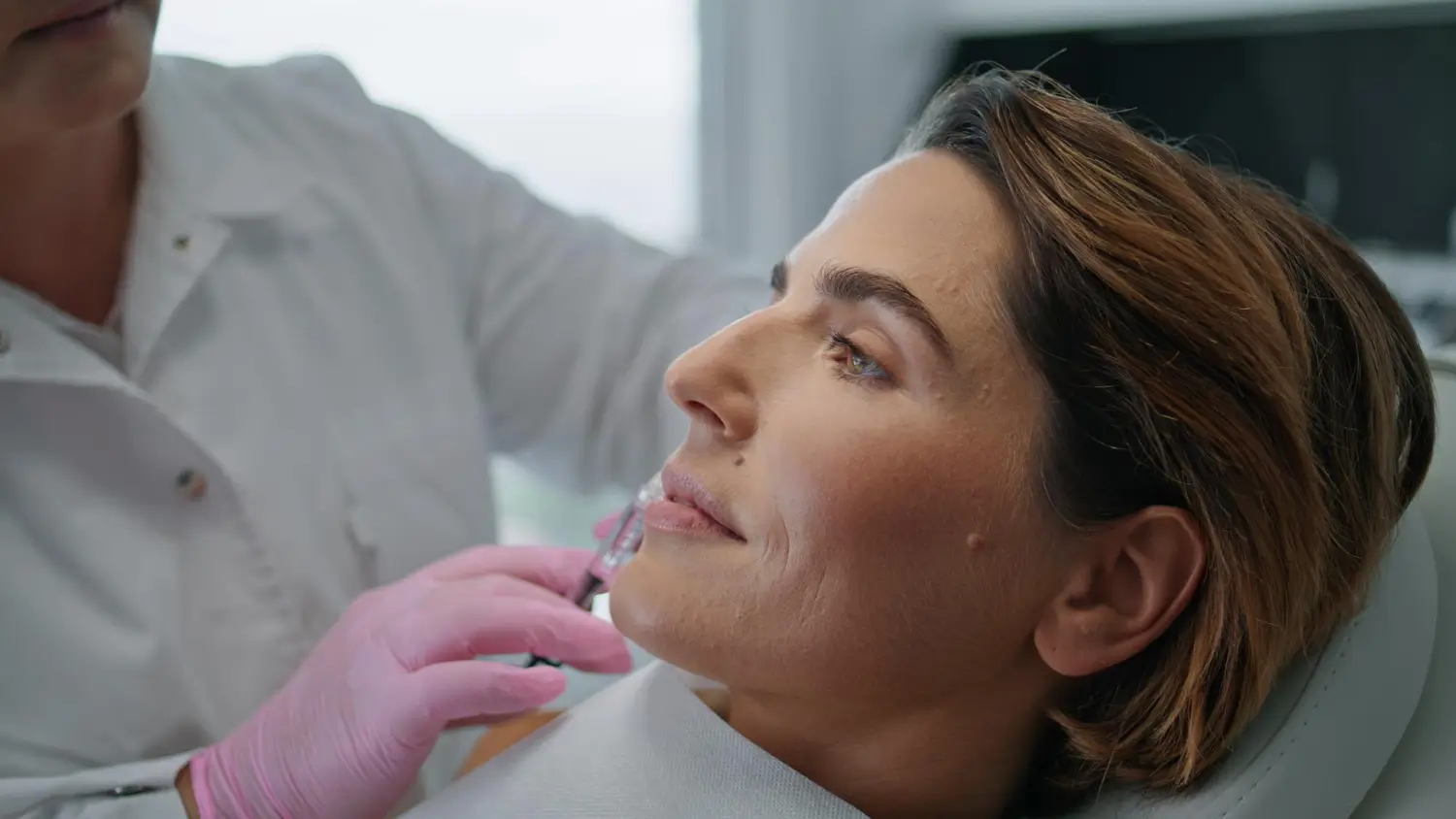 doctor prepares patient for skin booster treatment