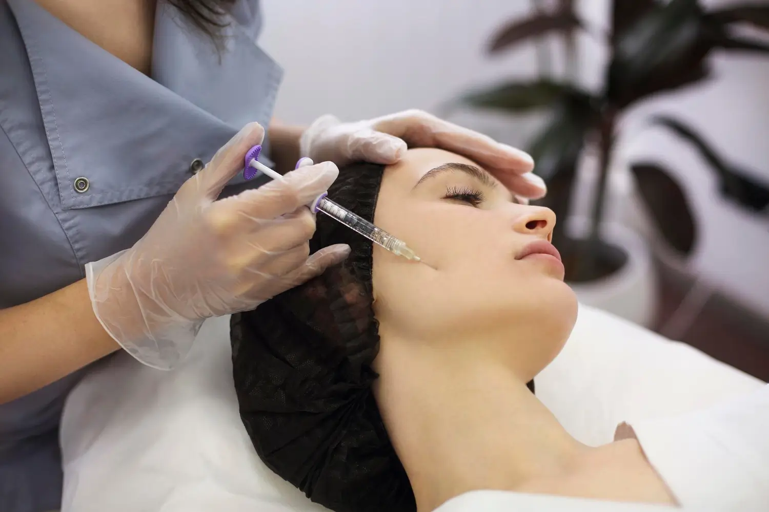 A professional expertly injects dermal filler for facial rejuvenation.