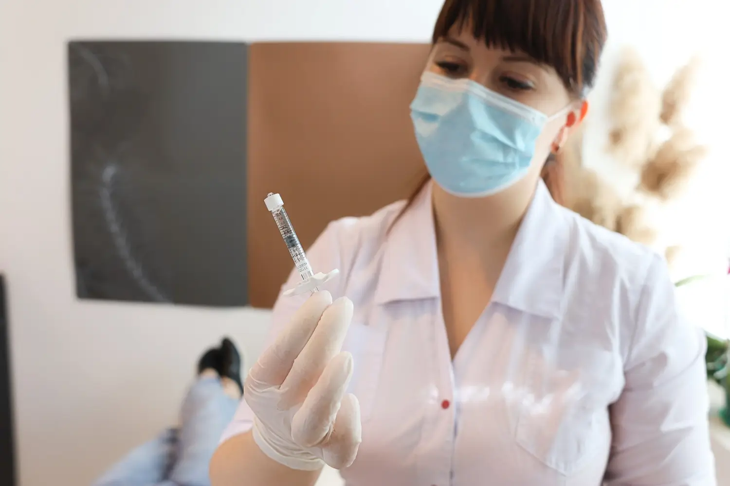 doctor inspects the injection before the operation