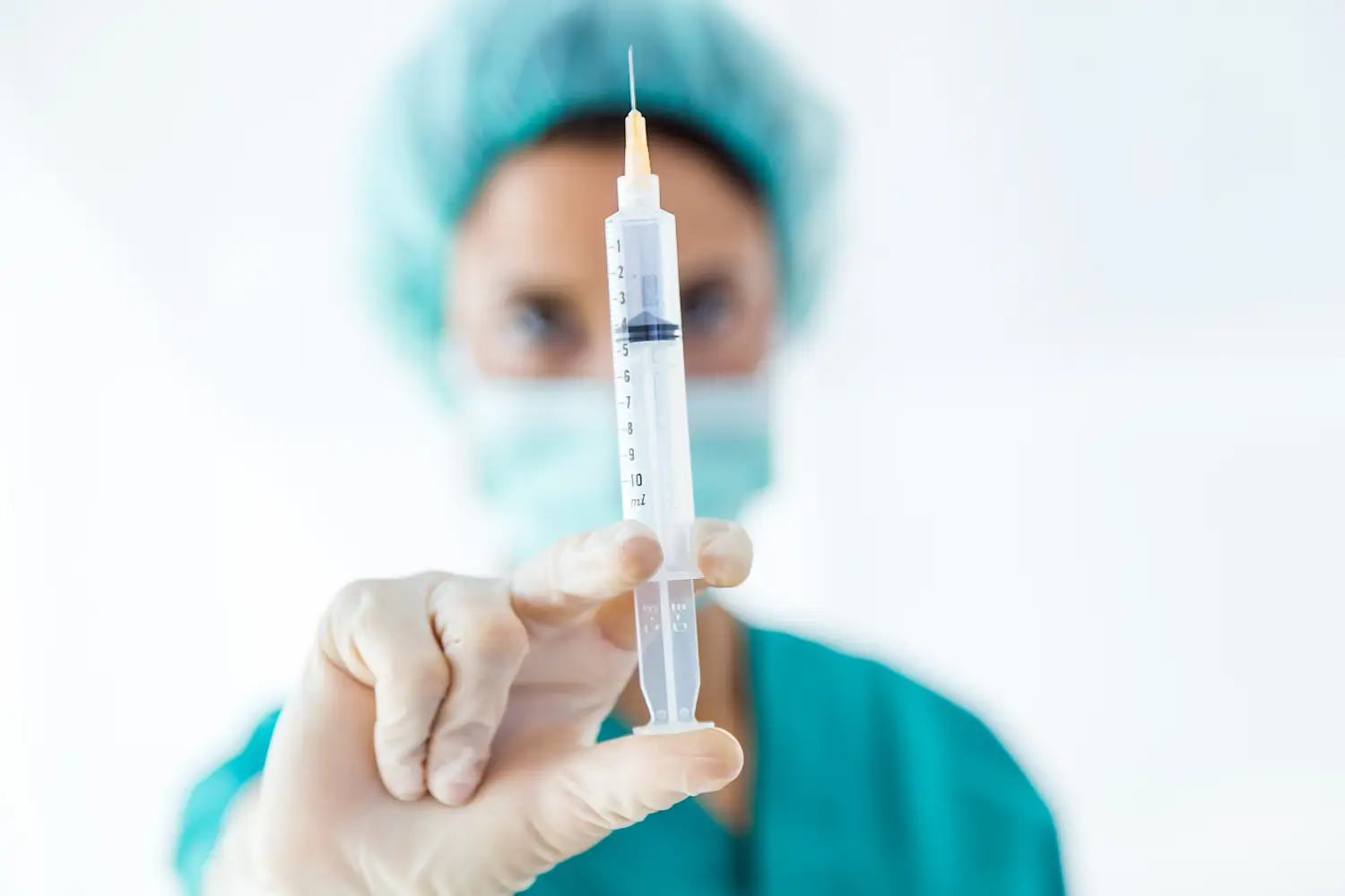 doctor holding a syringe with filler