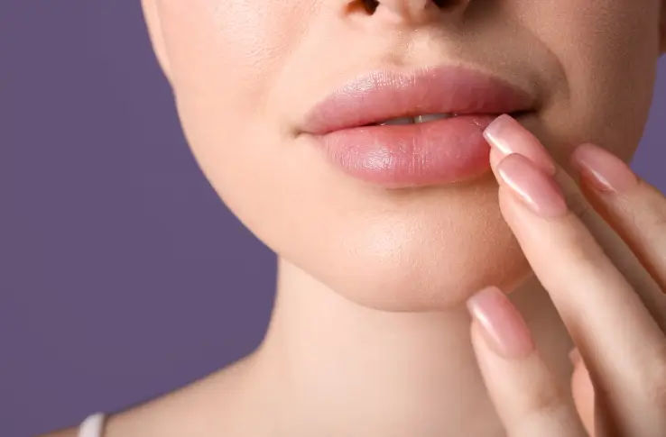 woman touching her pouty and smooth lips