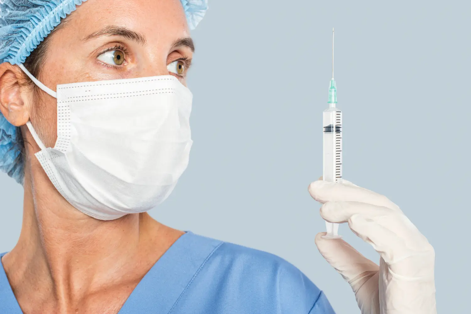 doctor checking on the syringe before injection
