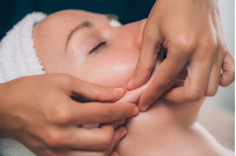 doctor pinches the patient's face