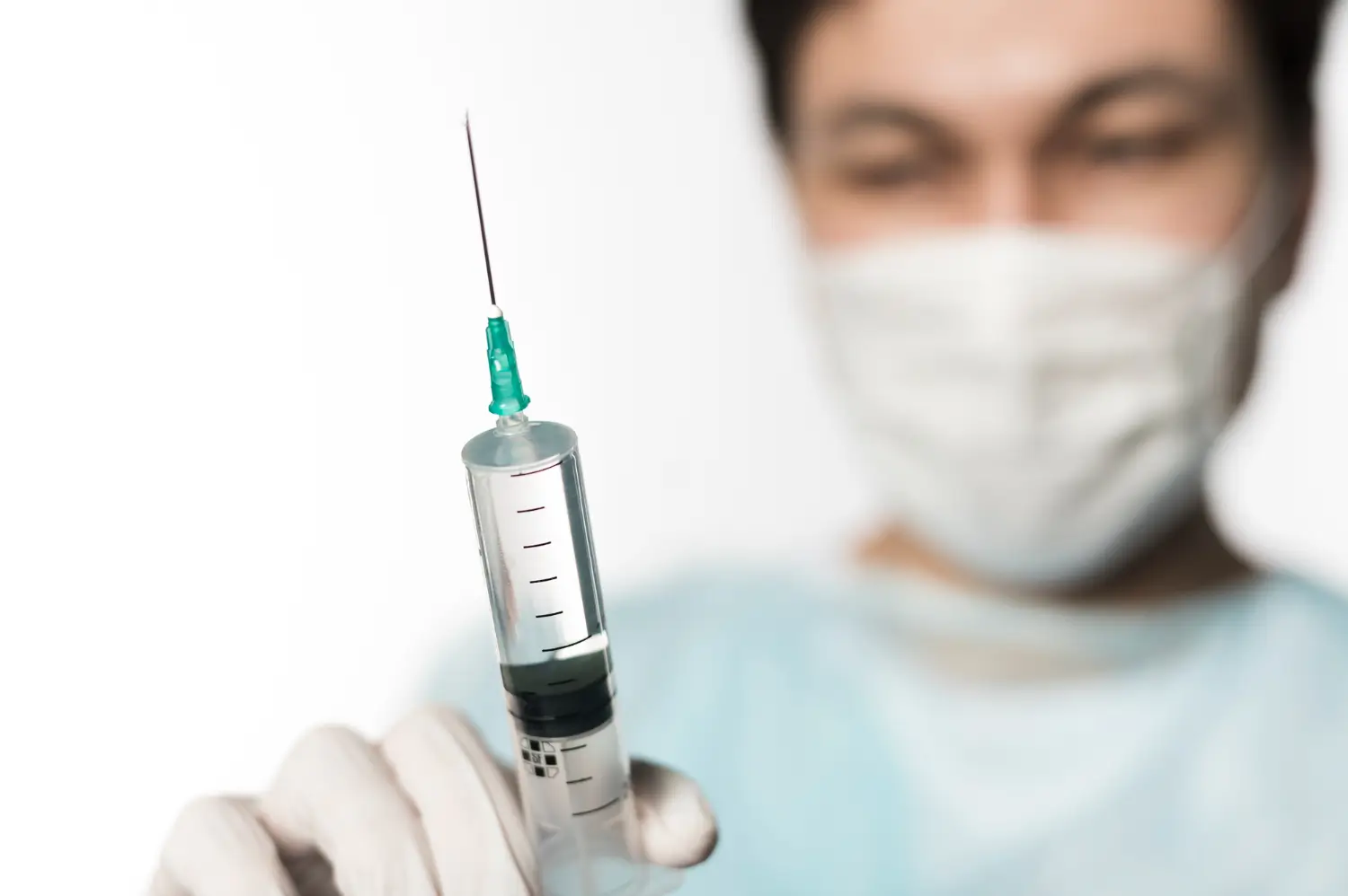 doctor gets the injection ready for the patient