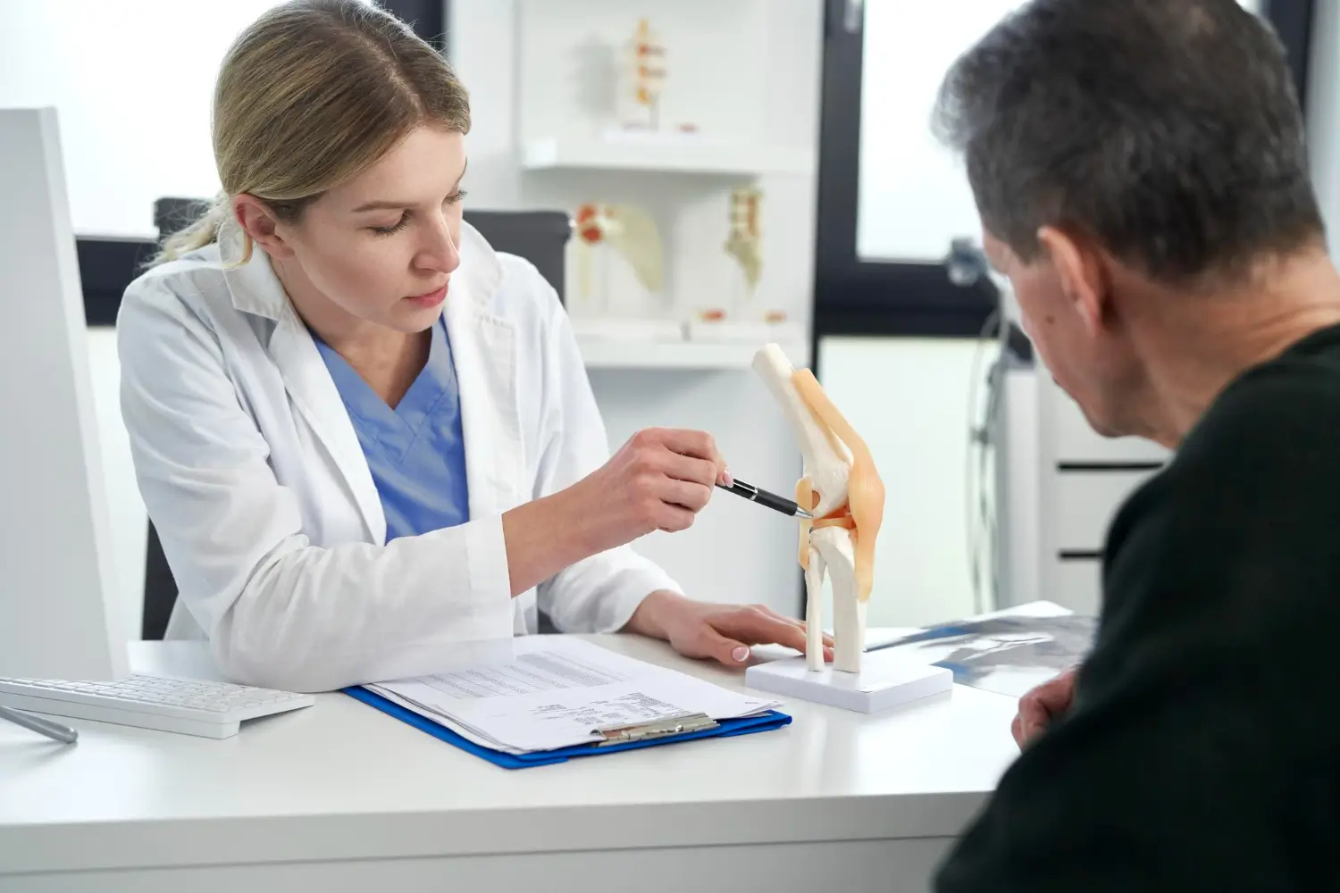 doctor explaining the bones and joints to a patient