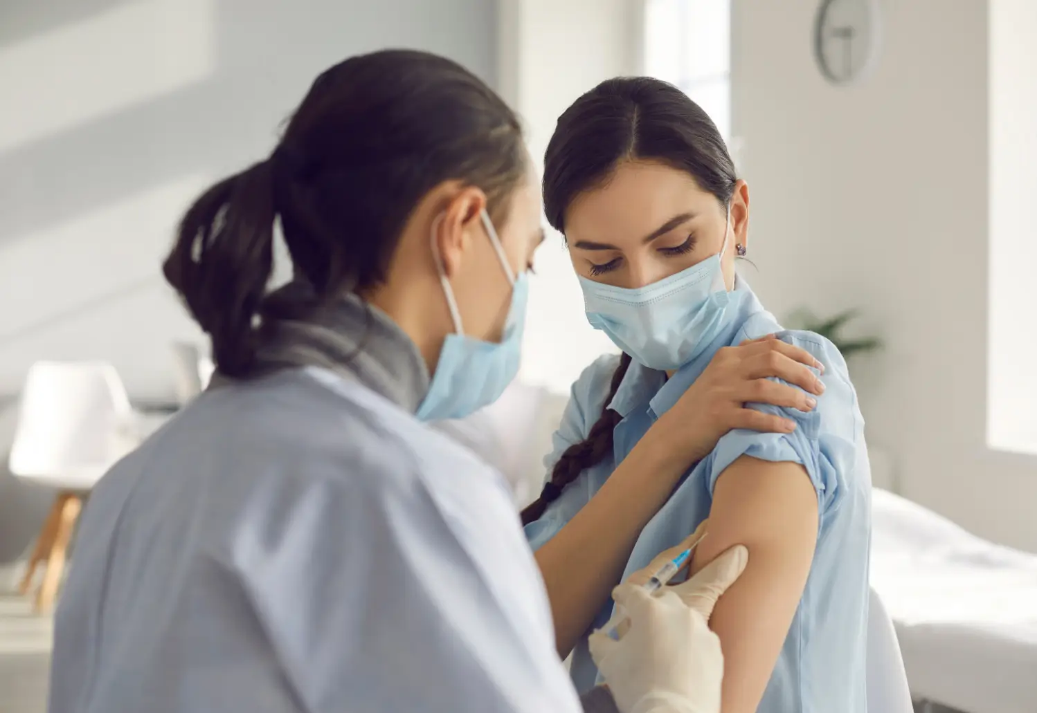 doctor carefully injects the treatment in her arm