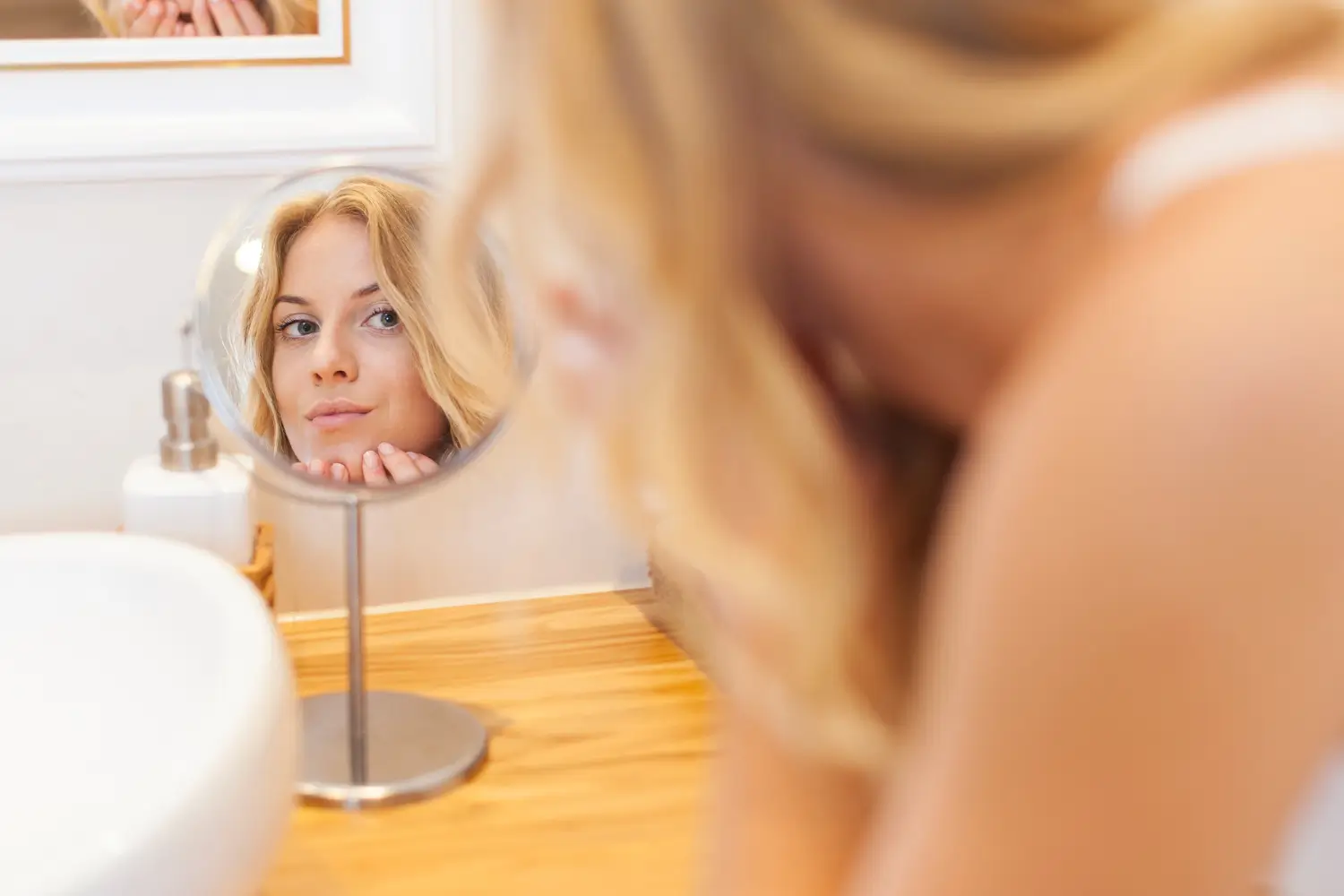 she is looking at herself in the mirror