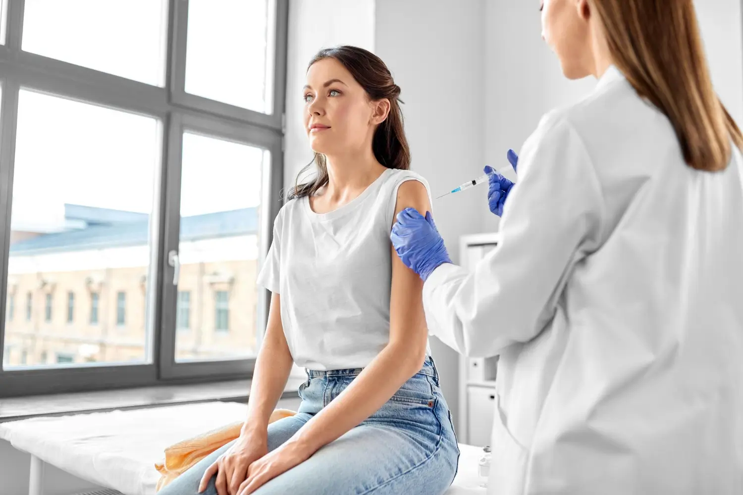 woman calmly sits while waiting for the injection