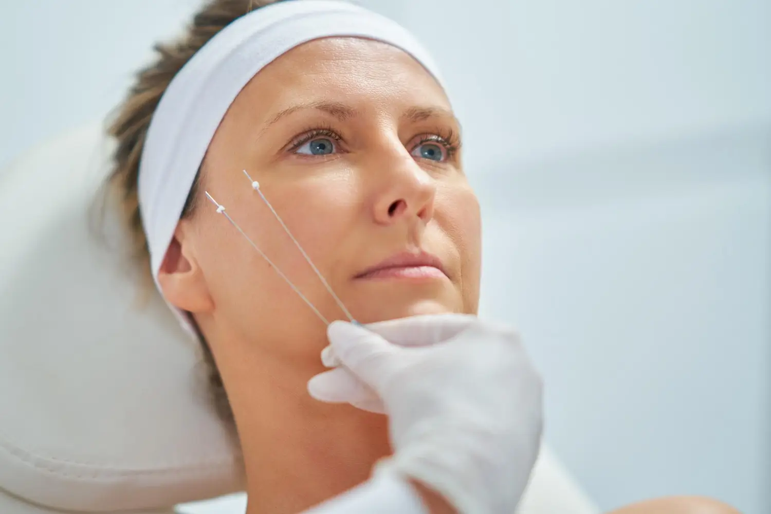 showing the threads to be used for her operation