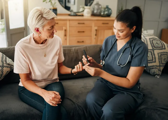 Nurse assists a patient with blood sugar testing, vital for diabetes management and personalized care.