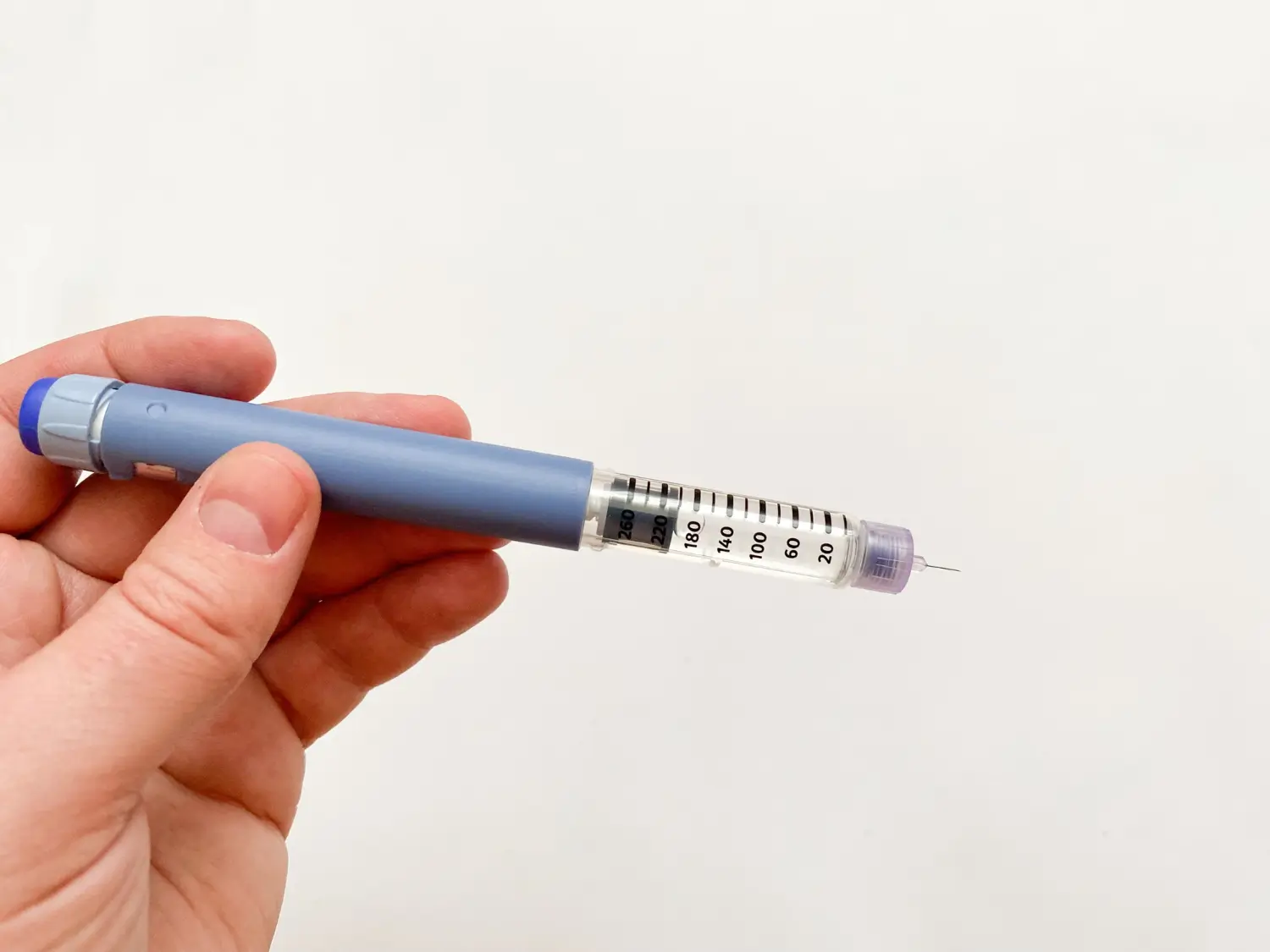 patient holding the insulin making sure of the dosage