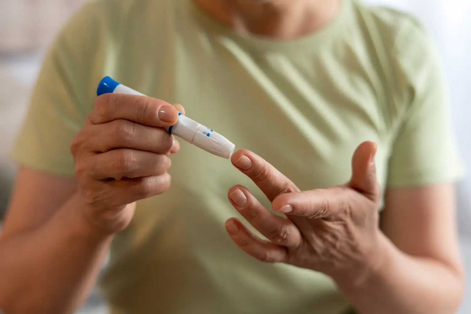 Patient takes a blood sugar test for monitoring before treatment.