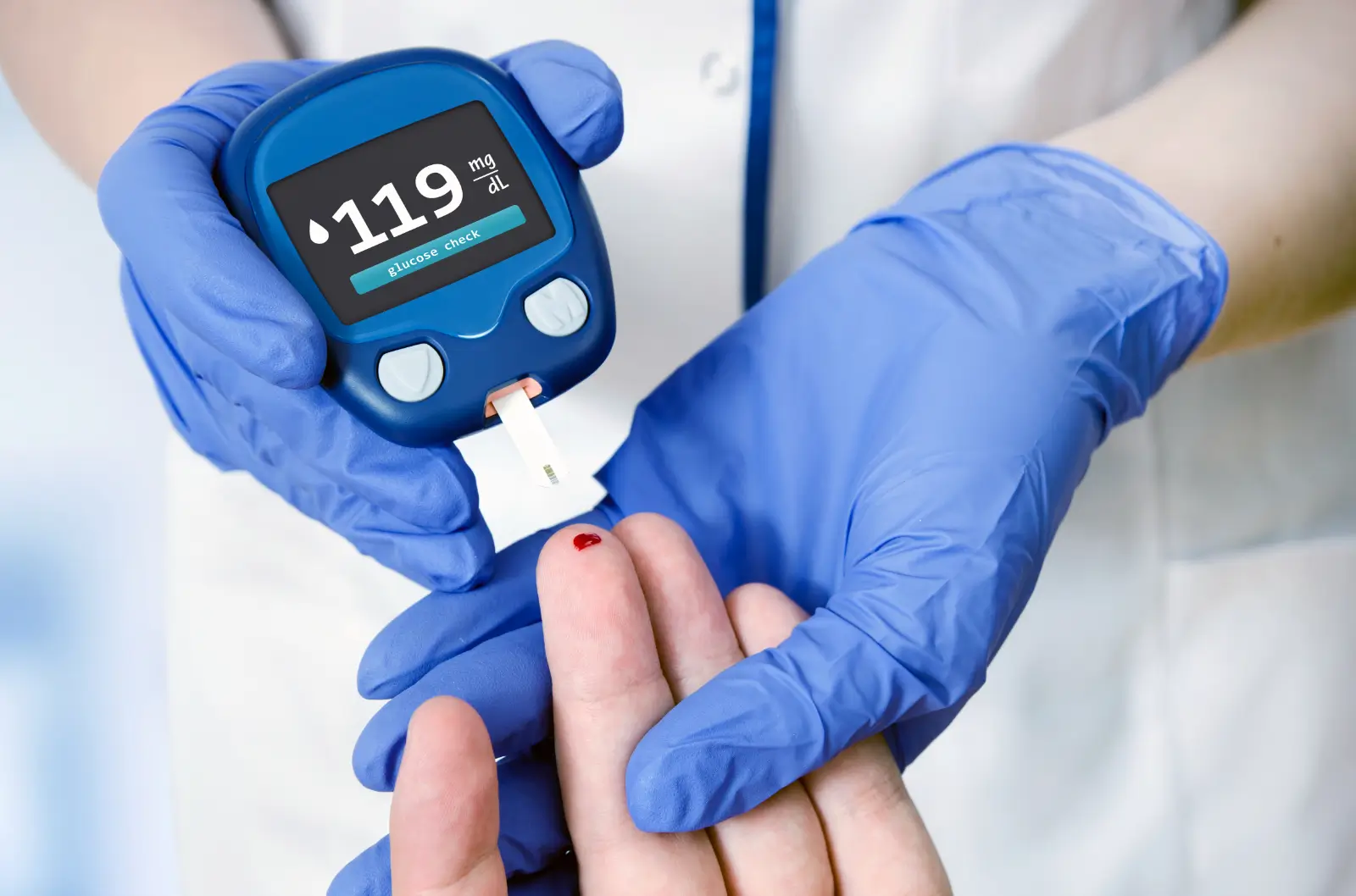 After checking blood sugar, doctor gets a normal result from the patient.