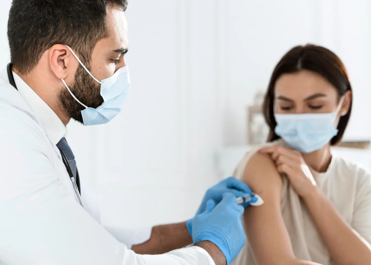 doctor injecting the medicine in her arm
