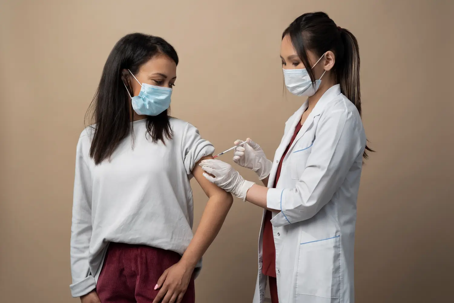 doctor injecting on the patient's arm