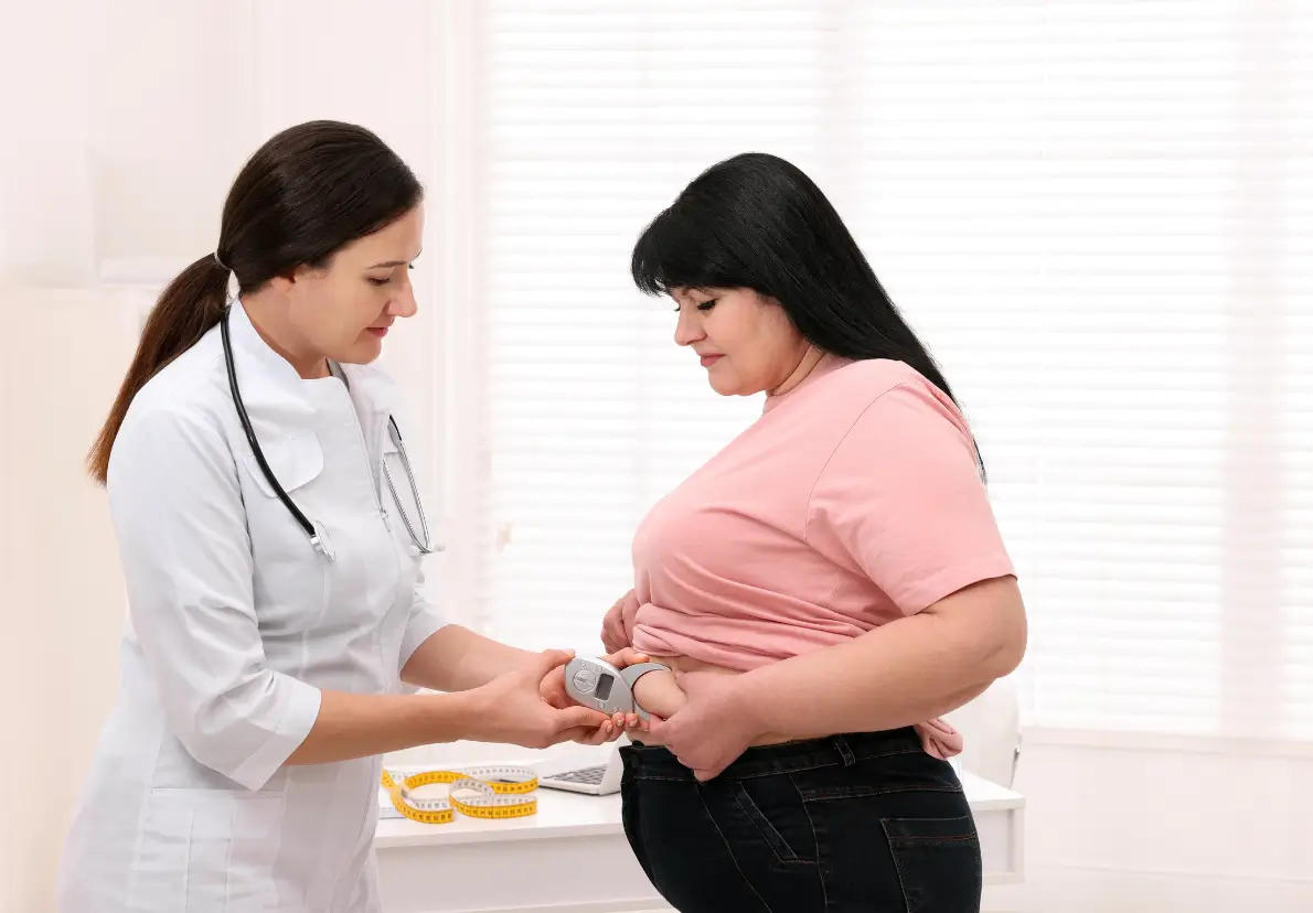 doctor checks the patient's excess fat