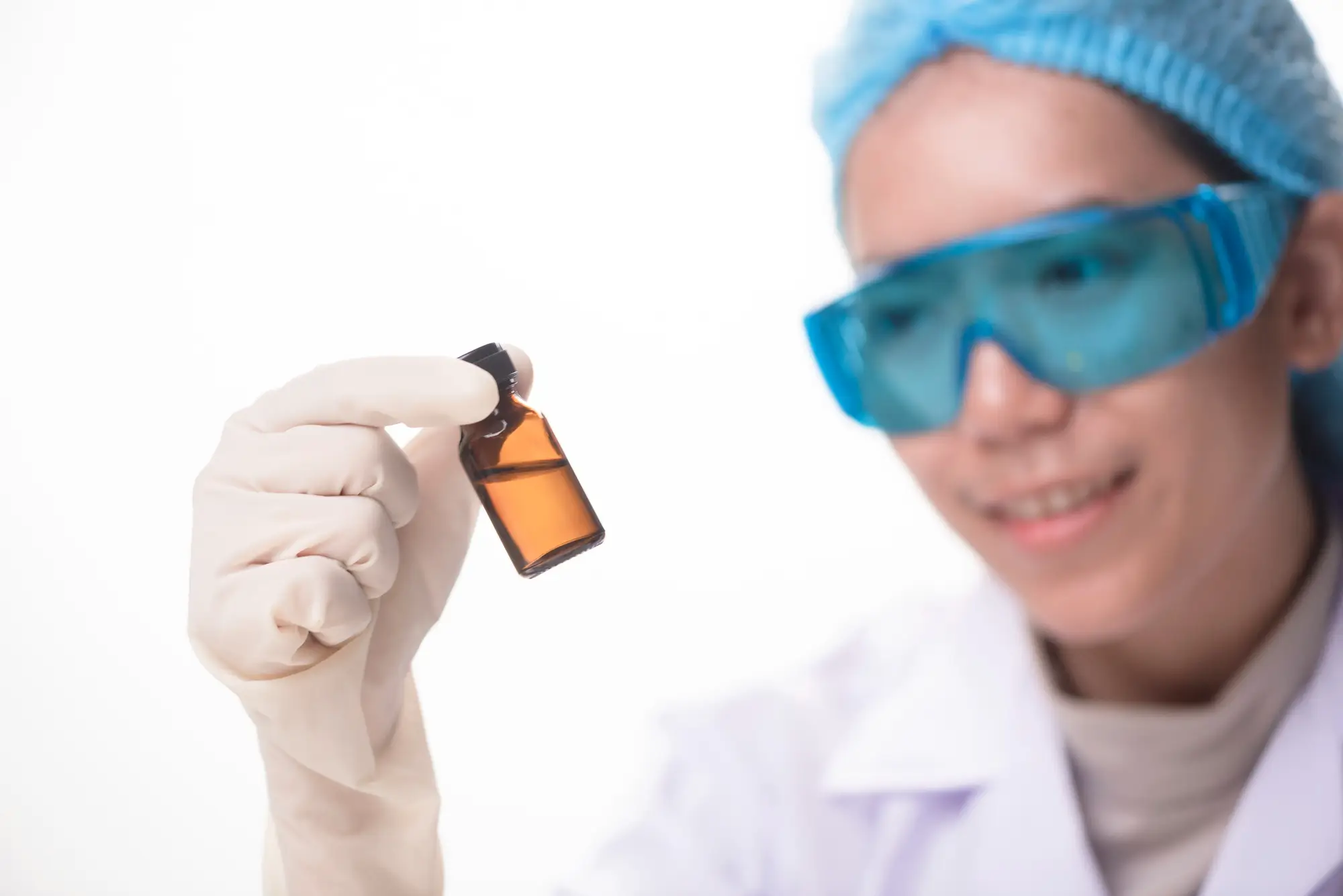 doctor smiling at the newly developed treatment in vial