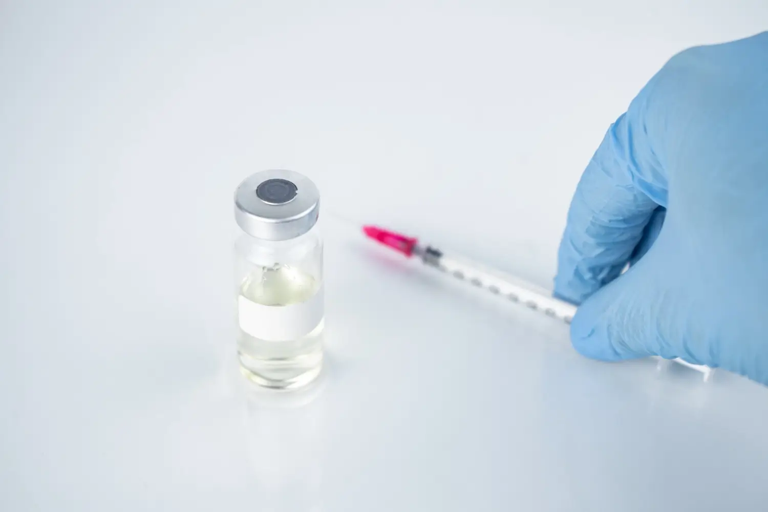 The vial and syringe of the injectable treatment are on the table.
